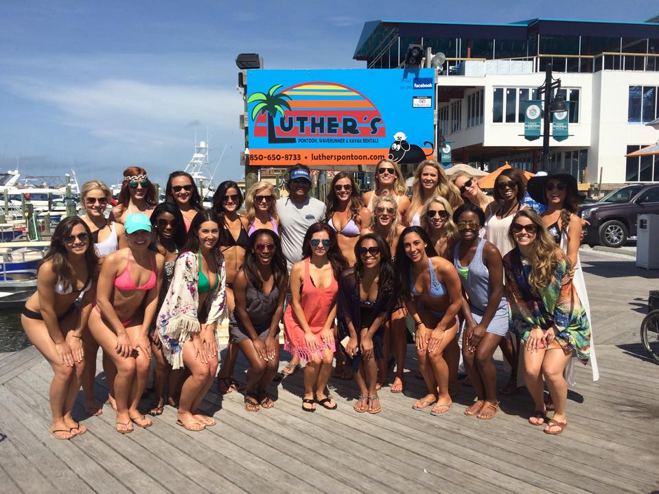 Large group of women in front of the Luther's Pontoon Rentals sign in Destin FL
