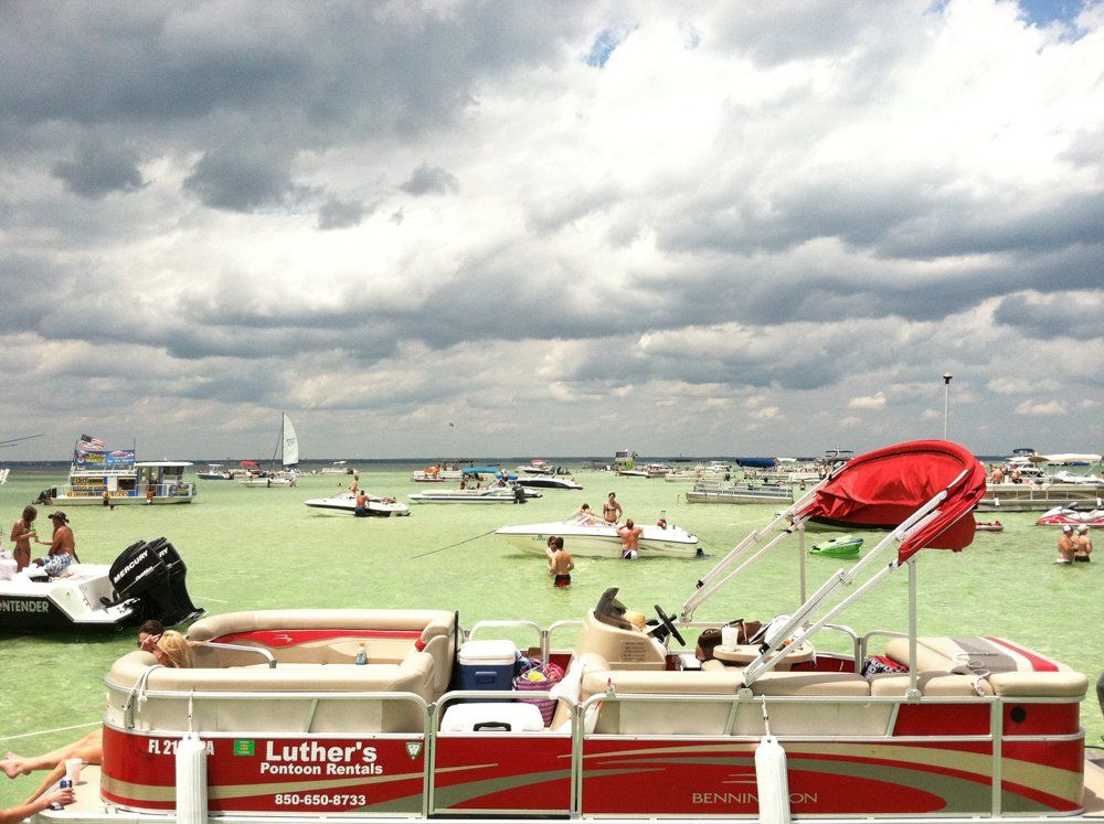 Red pontoon boat from Luther's Pontoon Rentals anchored at Crab Island