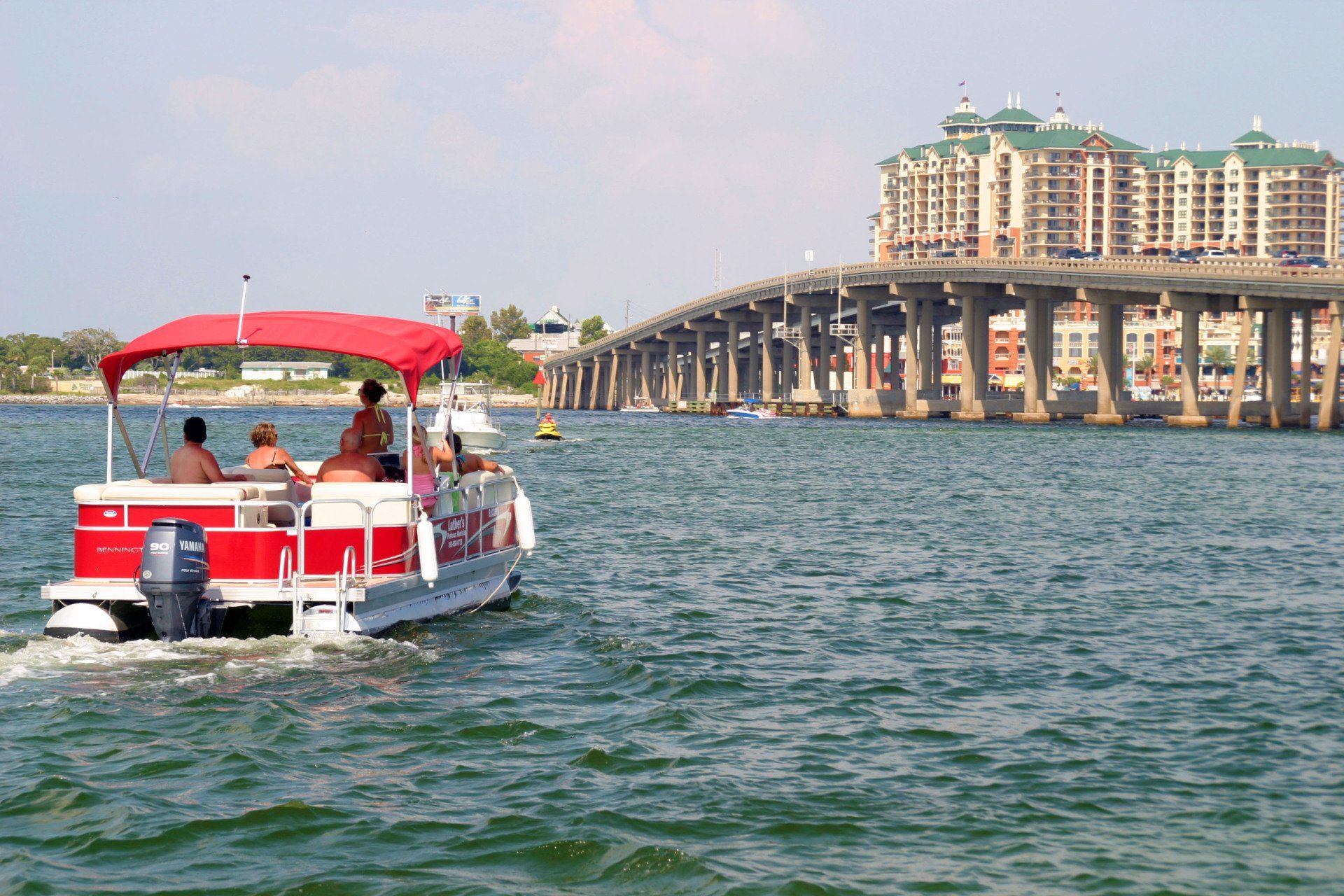 Group sitting inside a red 20ft pontoon boat rental in Destin FL