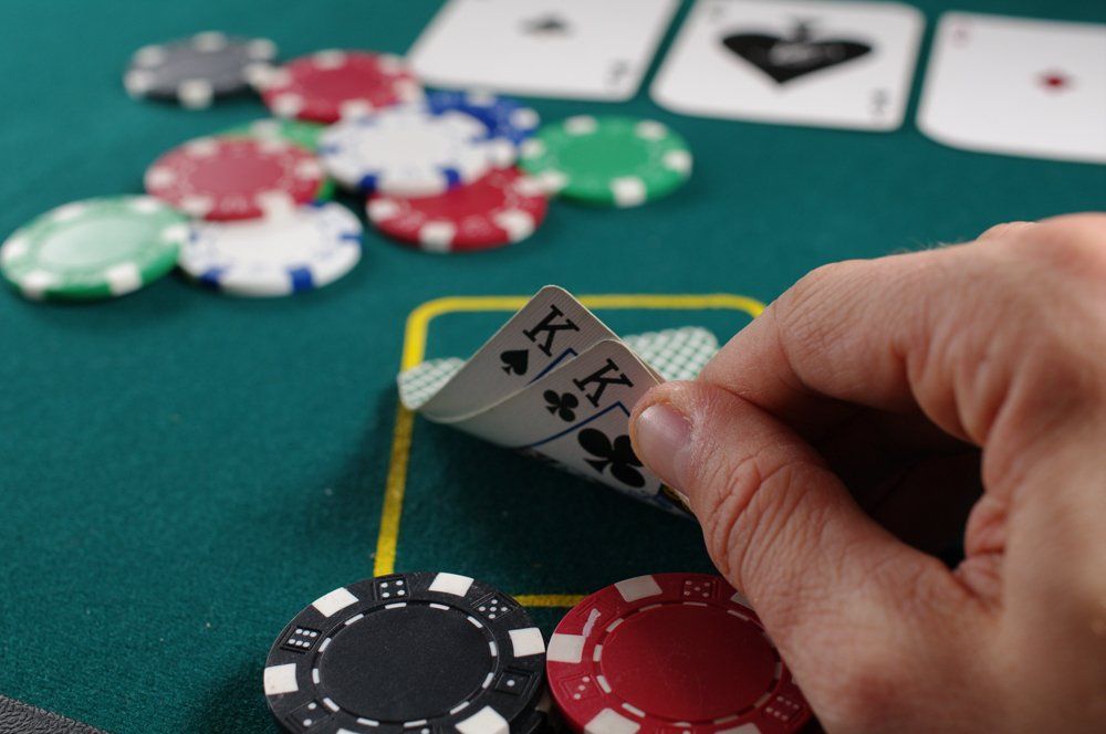 person playing poker and holding two cards