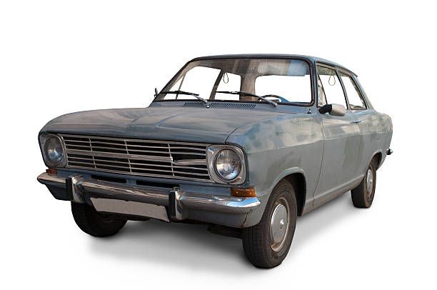 Gray vintage sedan with a worn exterior, front-left view on a white background