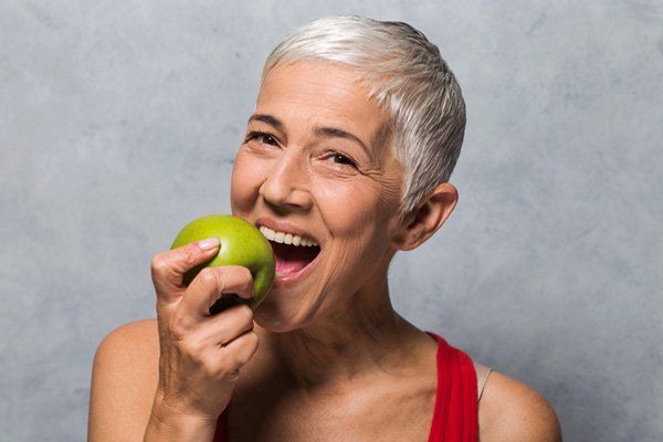 patient happy biting into apple