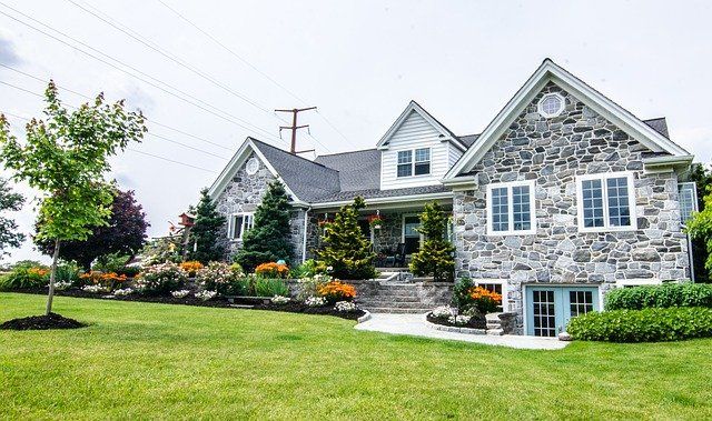Stone house with retaining wall on walkway