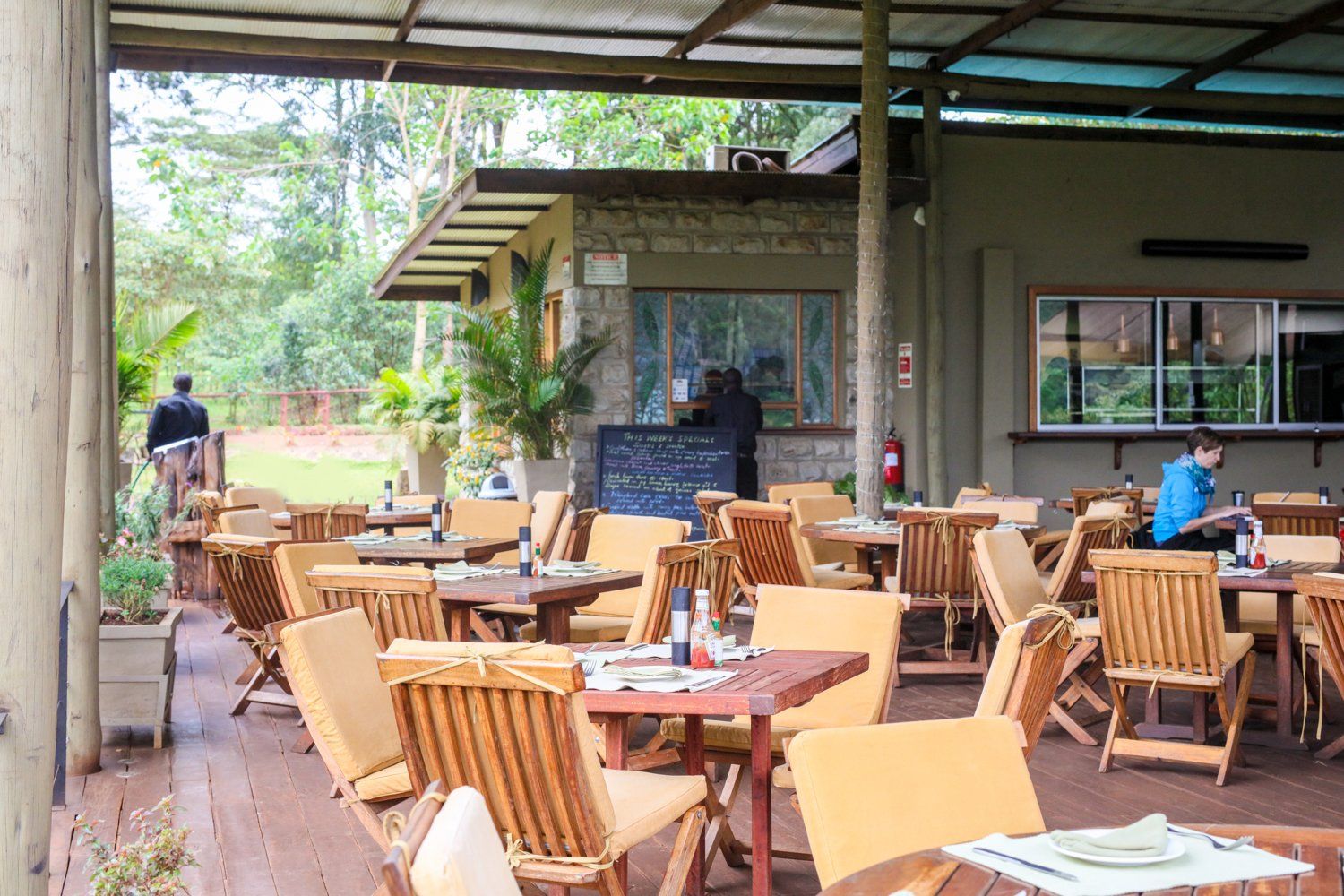 A restaurant with tables and chairs and a bar in the background