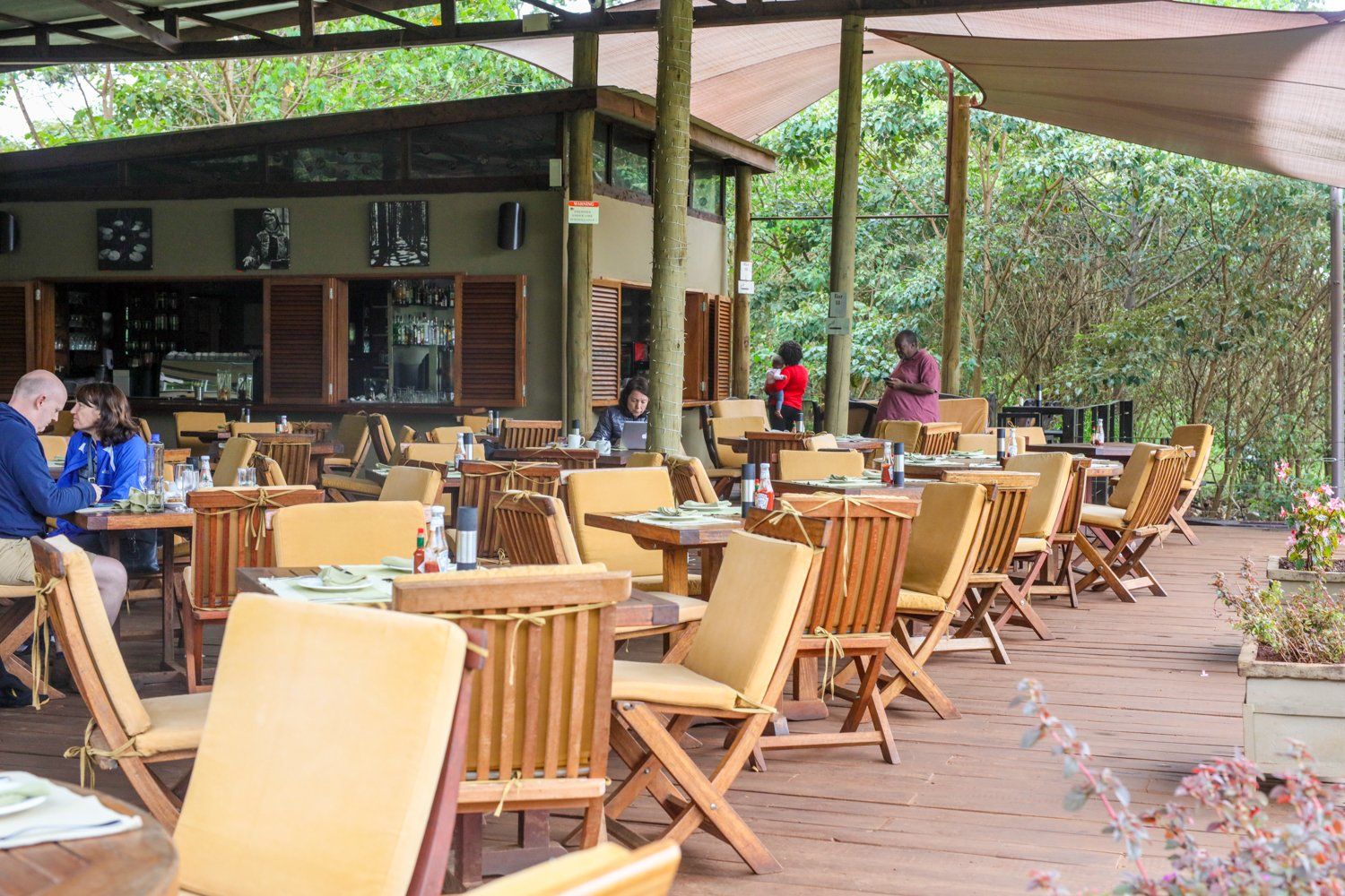 A group of people are sitting at tables in a restaurant.