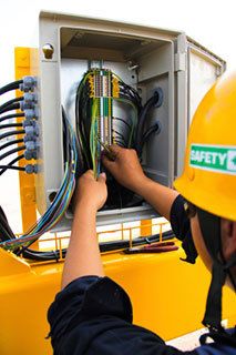 Electrician working on electrical panel