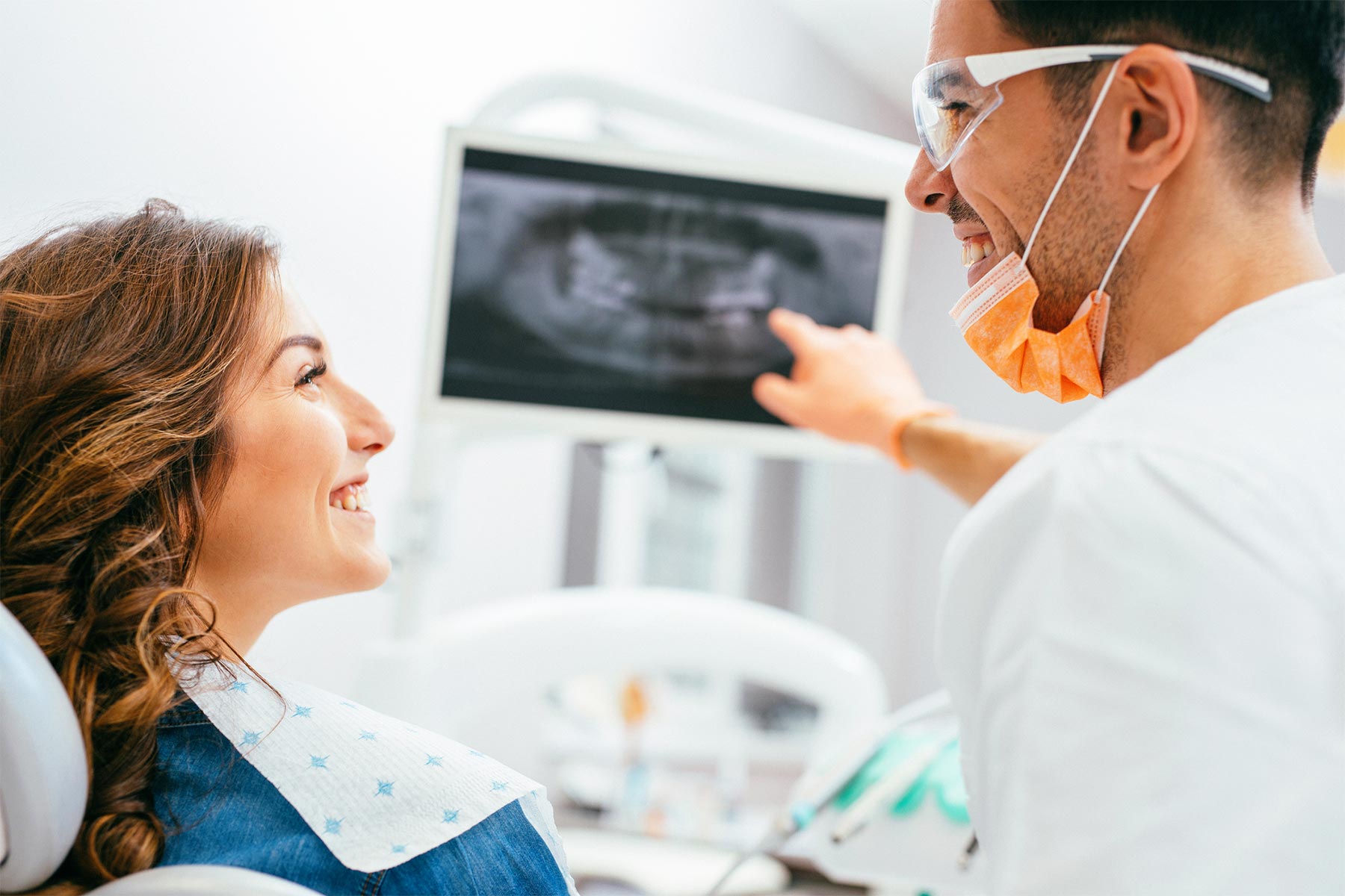 dentist showing patient xrays