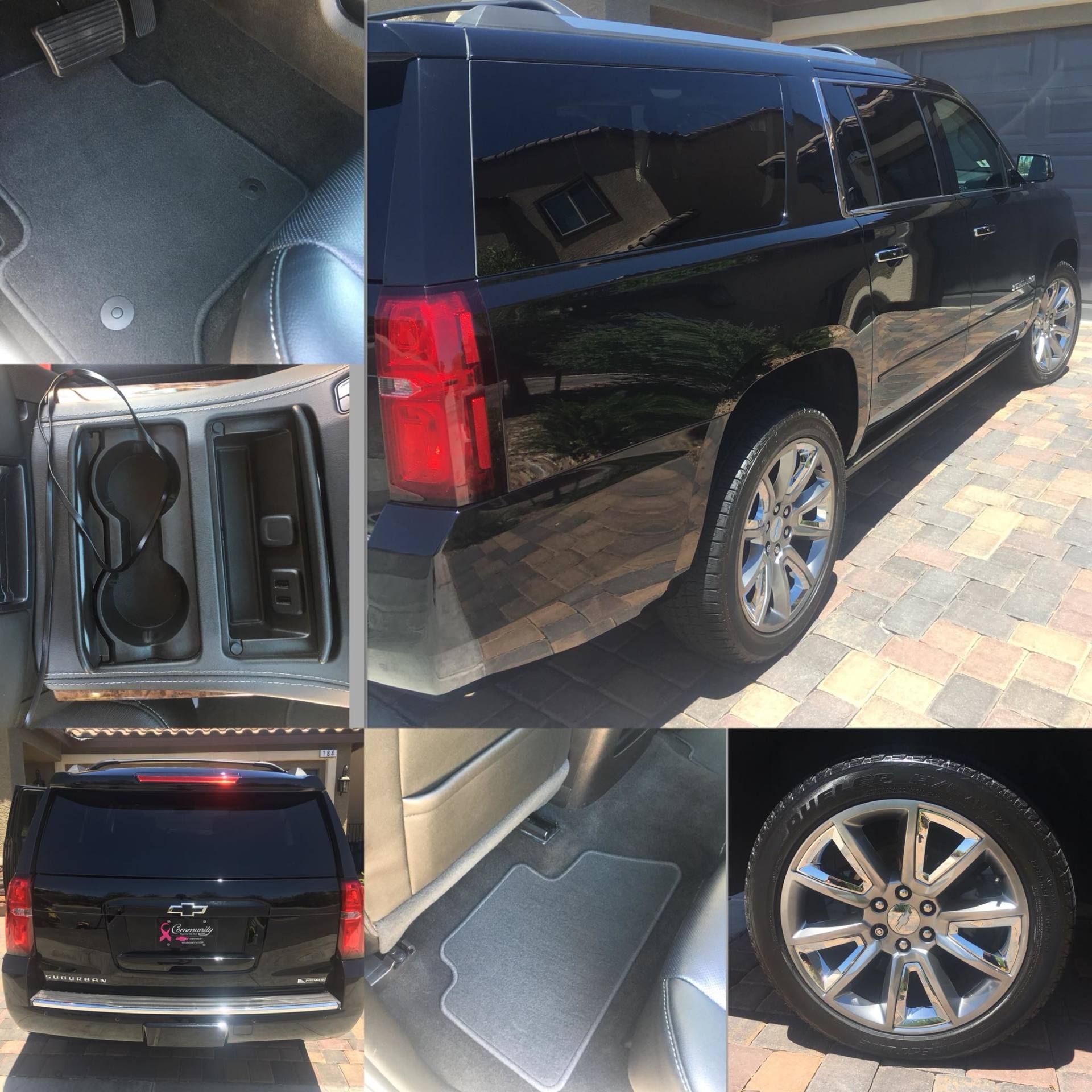 A black suv is parked on a brick driveway