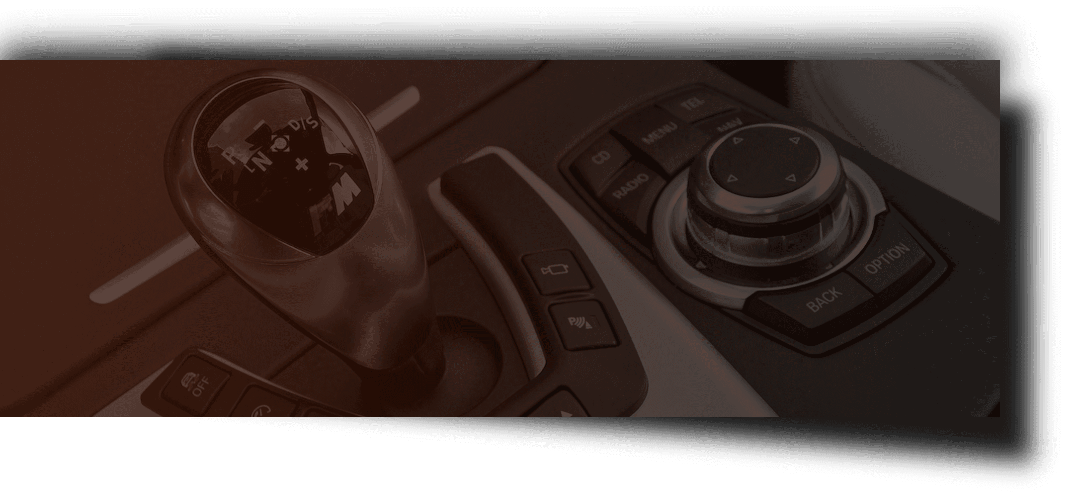 A close up of a car 's shifter and controls.