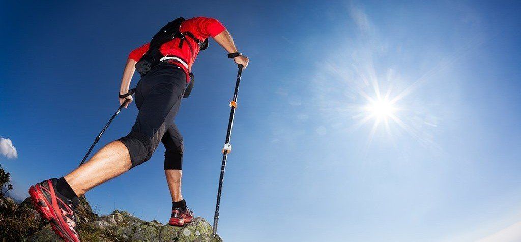 Person walking on mountain ridge, representing rolfing benefits.
