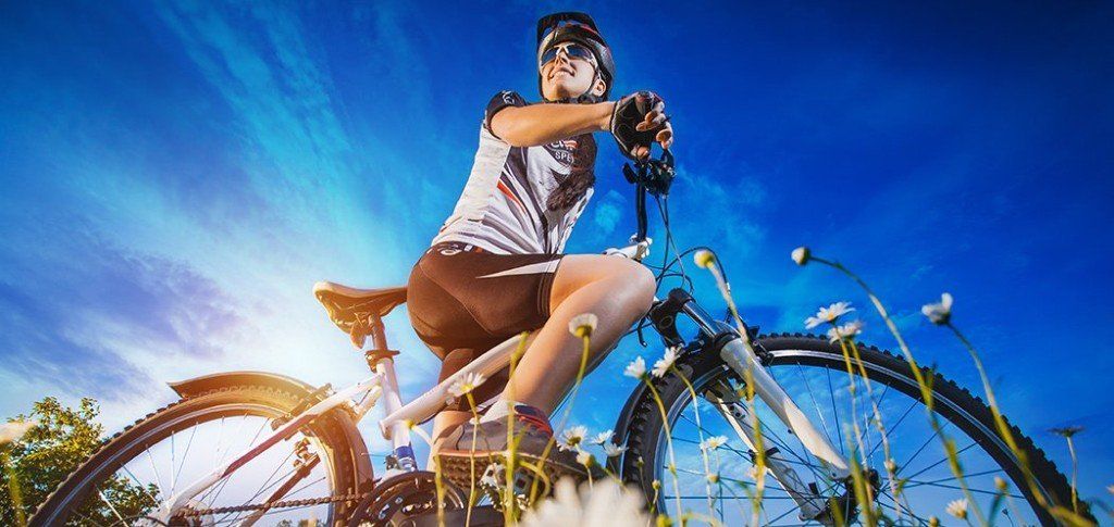 Woman on mountain bike, symbolizing benefits of borealis therapy in Anchorage, AK.