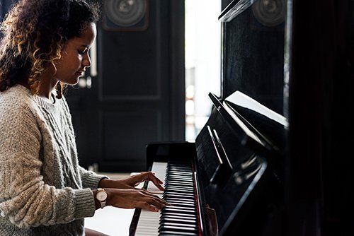 Used Piano - Woman Playing On A Piano in Nashville, TN