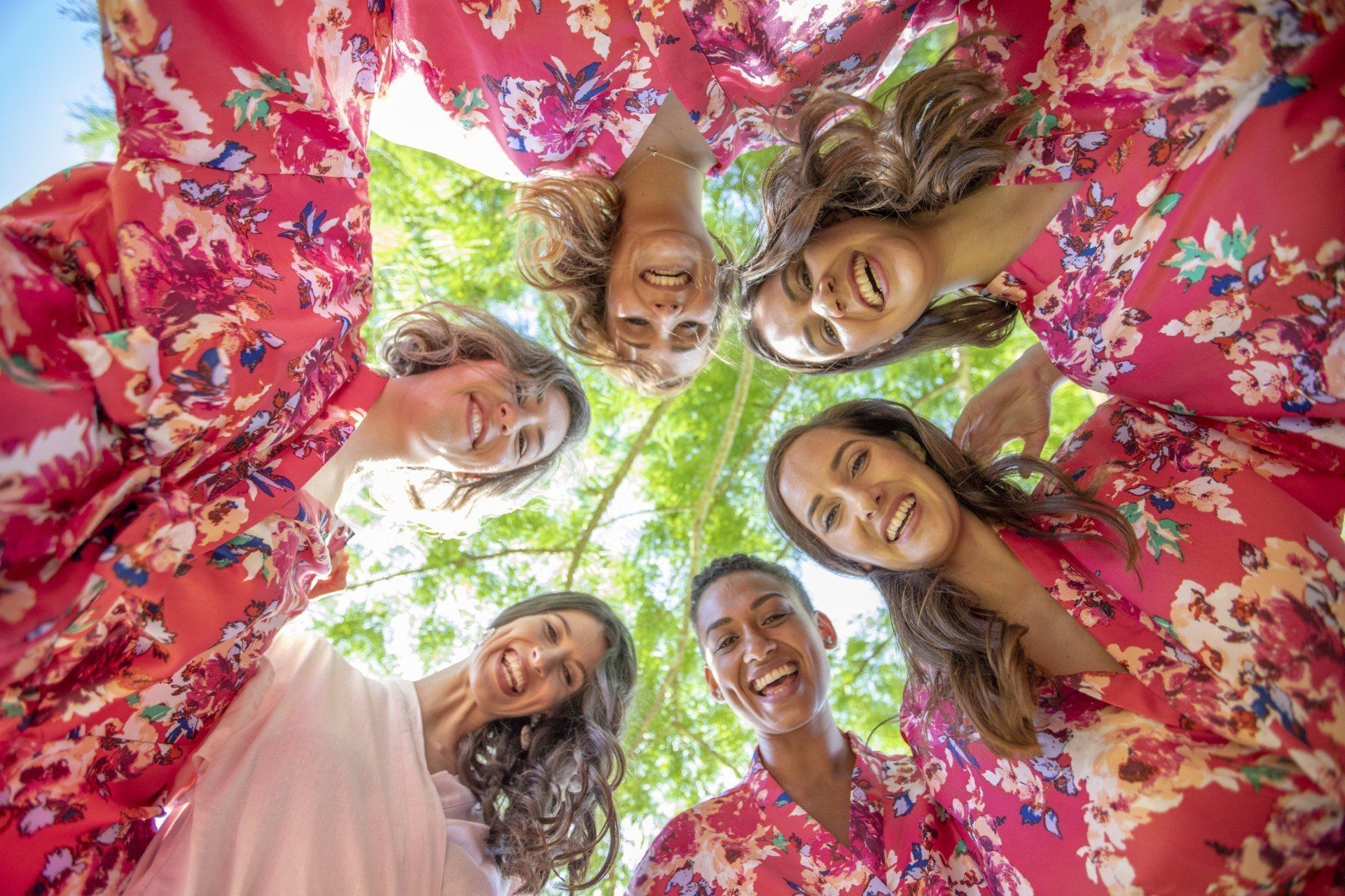 a group of women are standing in a circle and smiling .