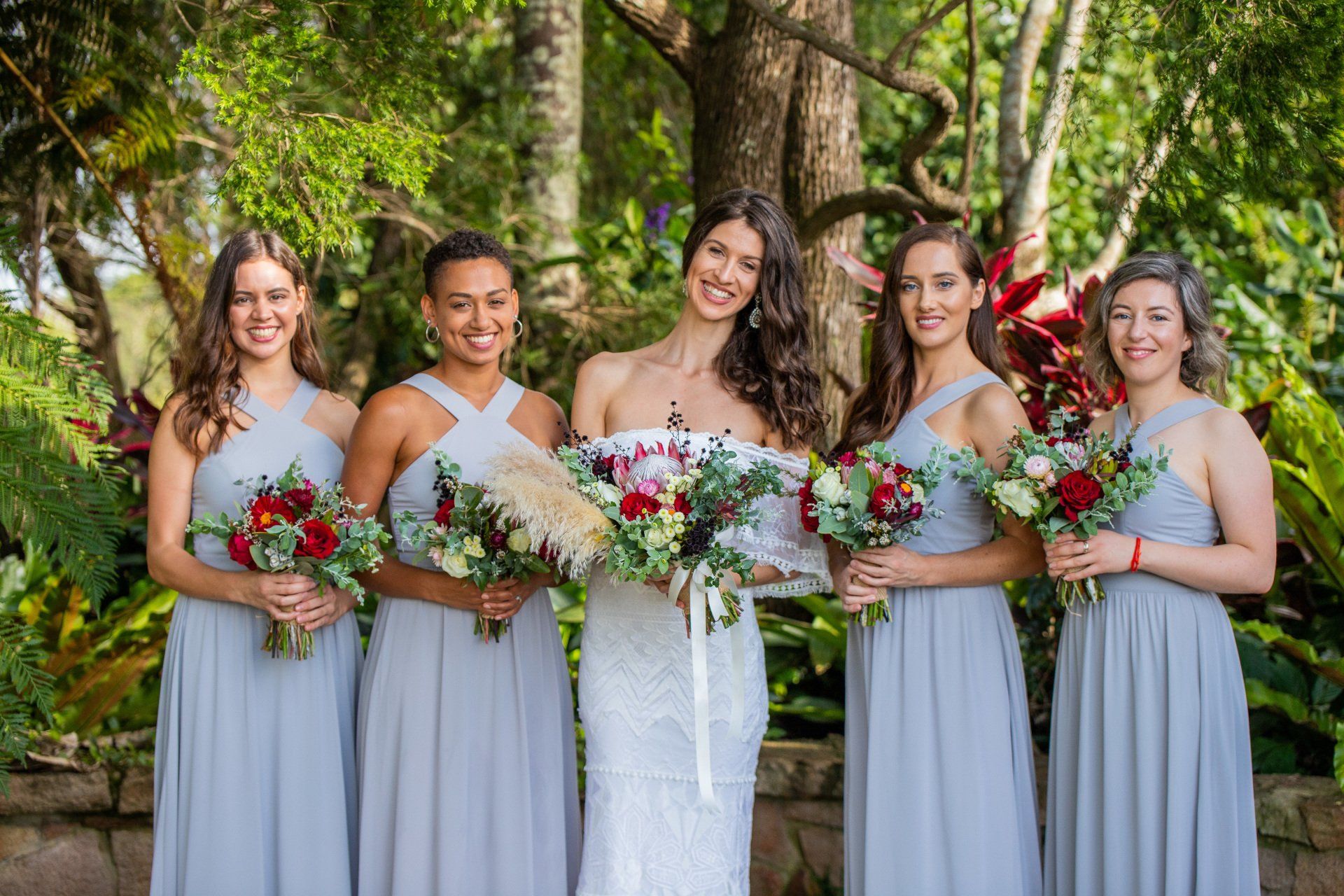 a bride and her bridesmaids are posing for a picture .