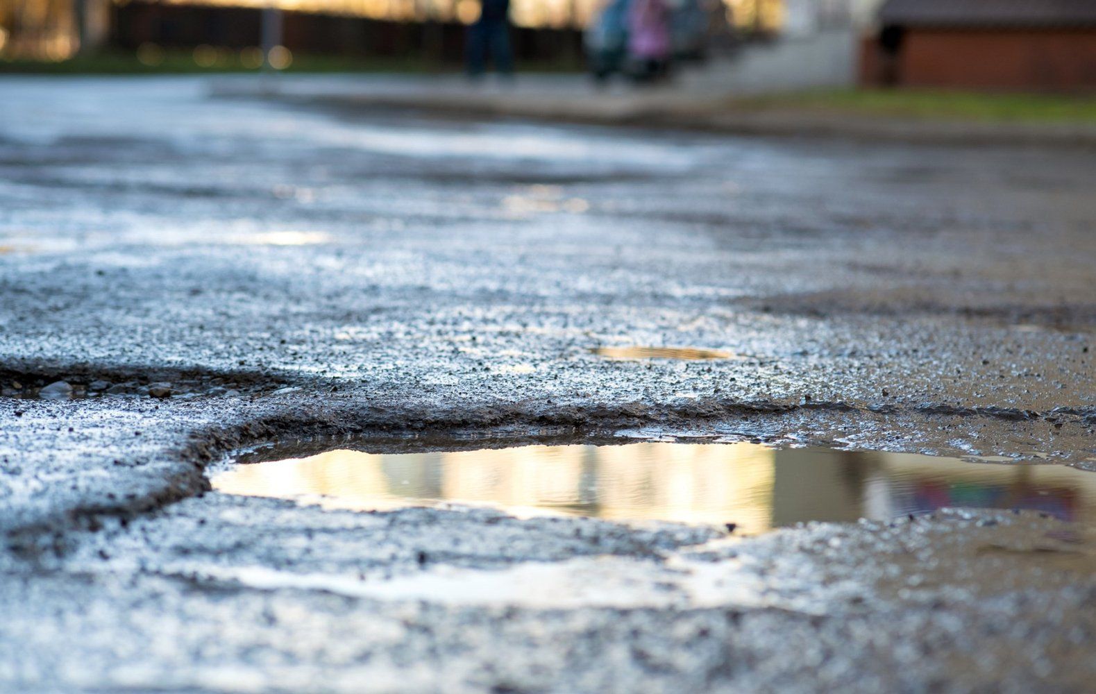 Damaged asphalt road — Coatesville, PA — Bill & Sons Paving LLC