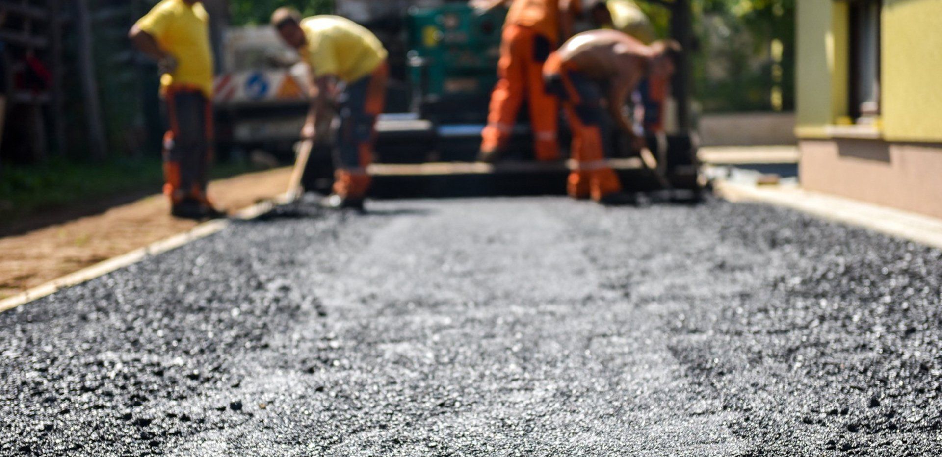 Workers doing asphalt emulsion seal coating — Coatesville, PA — Bill & Sons Paving LLC Workers doing asphalt emulsion seal coating — Coatesville, PA — Bill & Sons Paving LLC