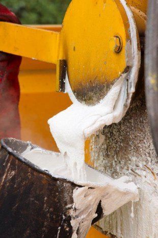 Paint can being filled with white paint