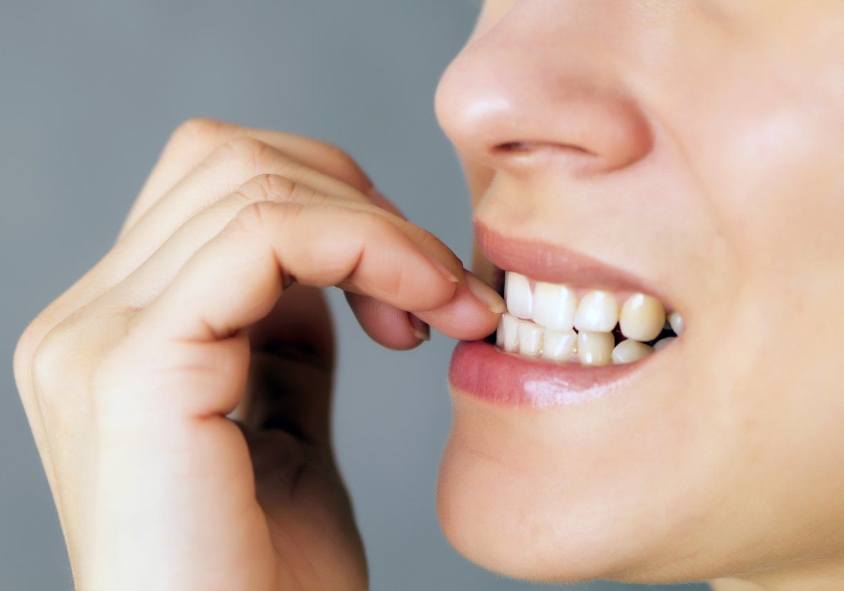 woman biting fingernails