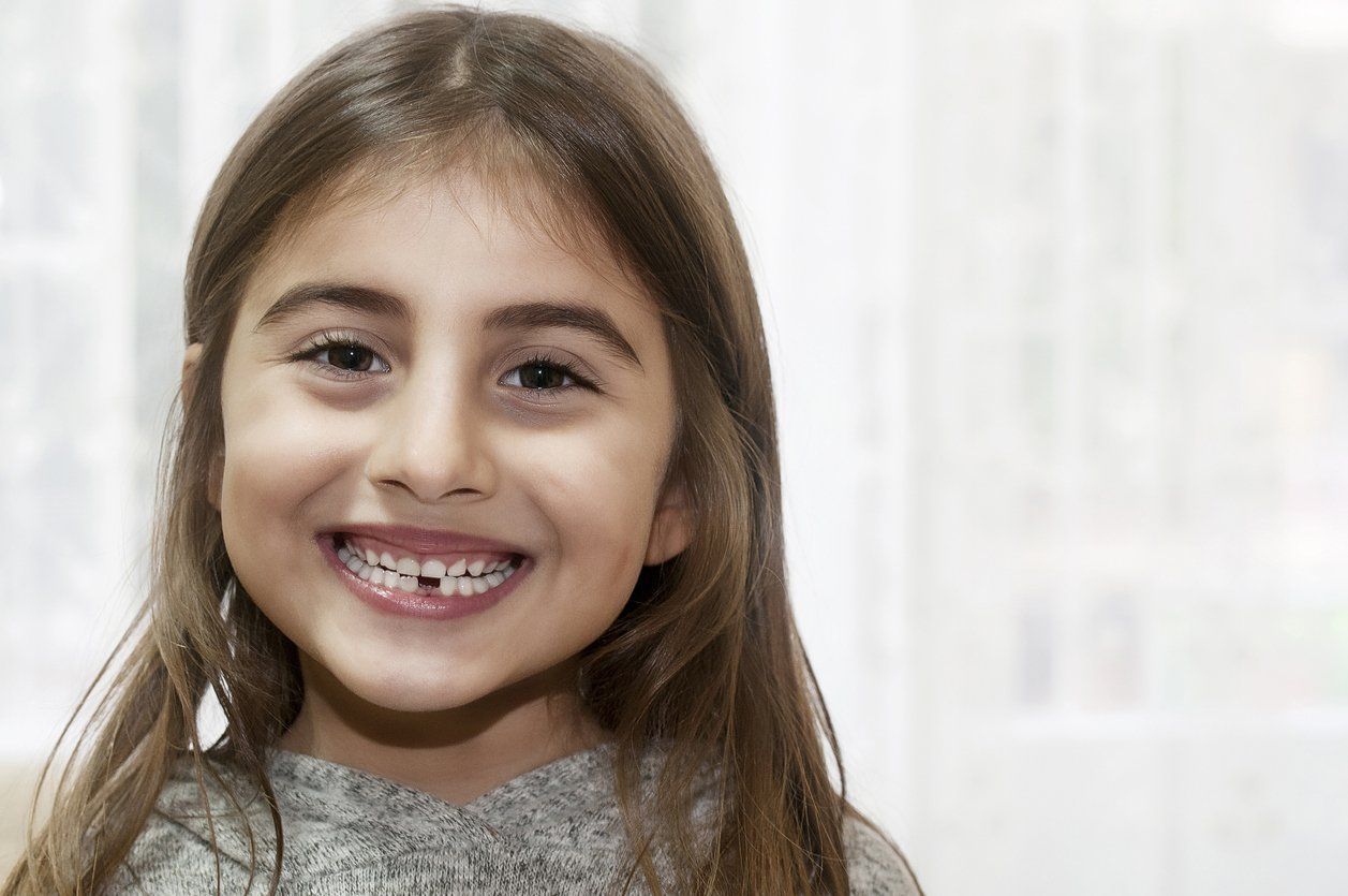 child with missing tooth