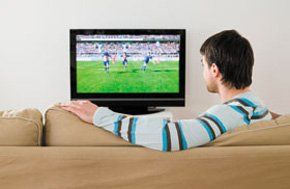 Digital TV - Aldershot, Hampshire - Attfield Aerials - Man watching TV on sofa