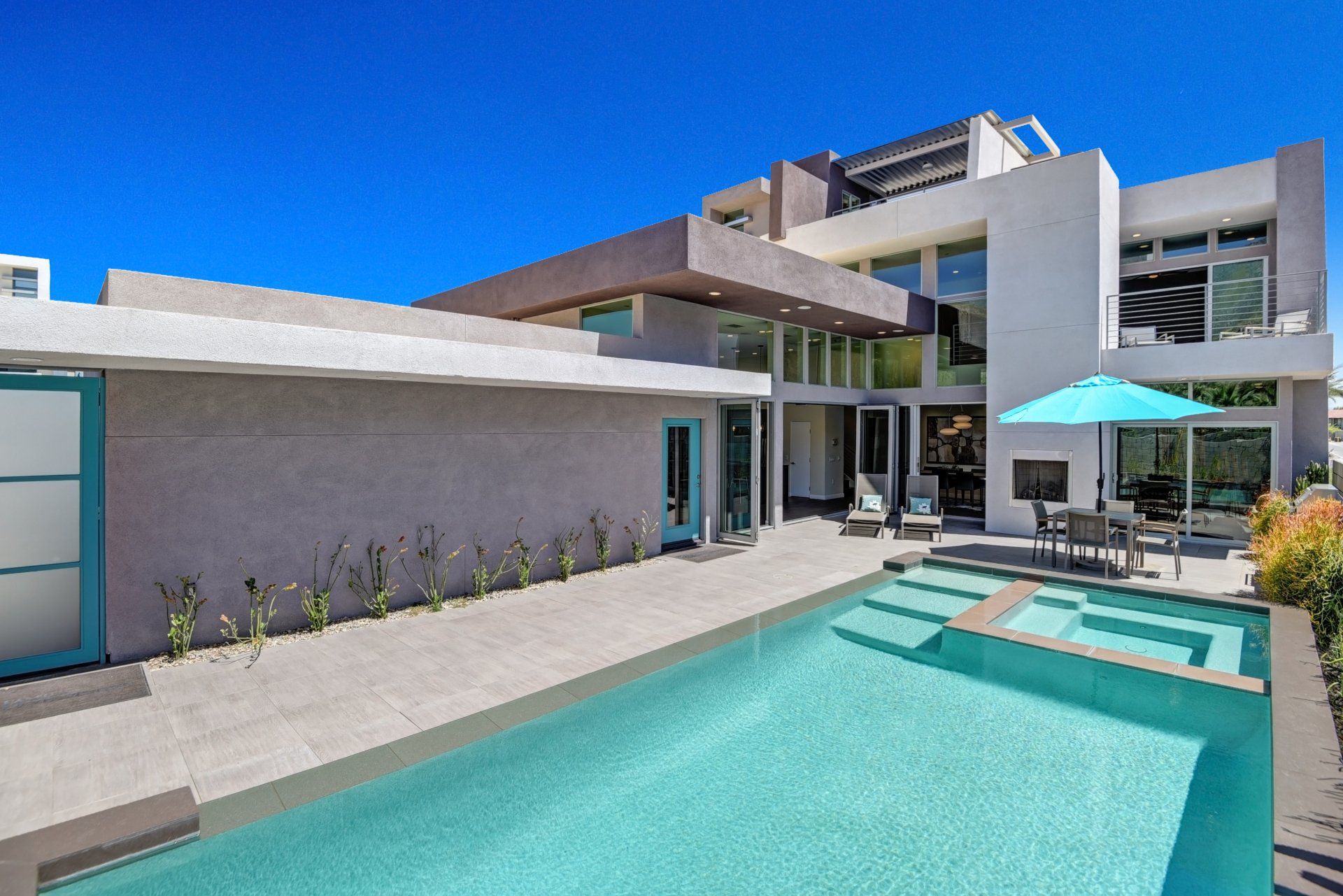 A large house with a swimming pool in front of it