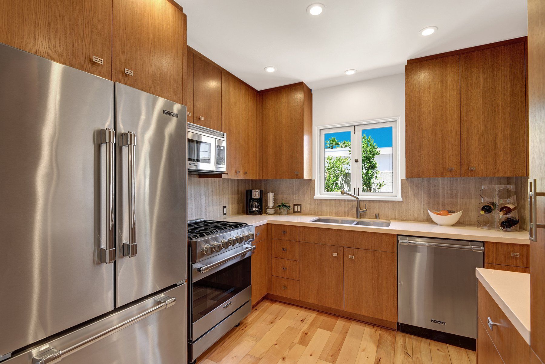 A kitchen with stainless steel appliances and wooden cabinets