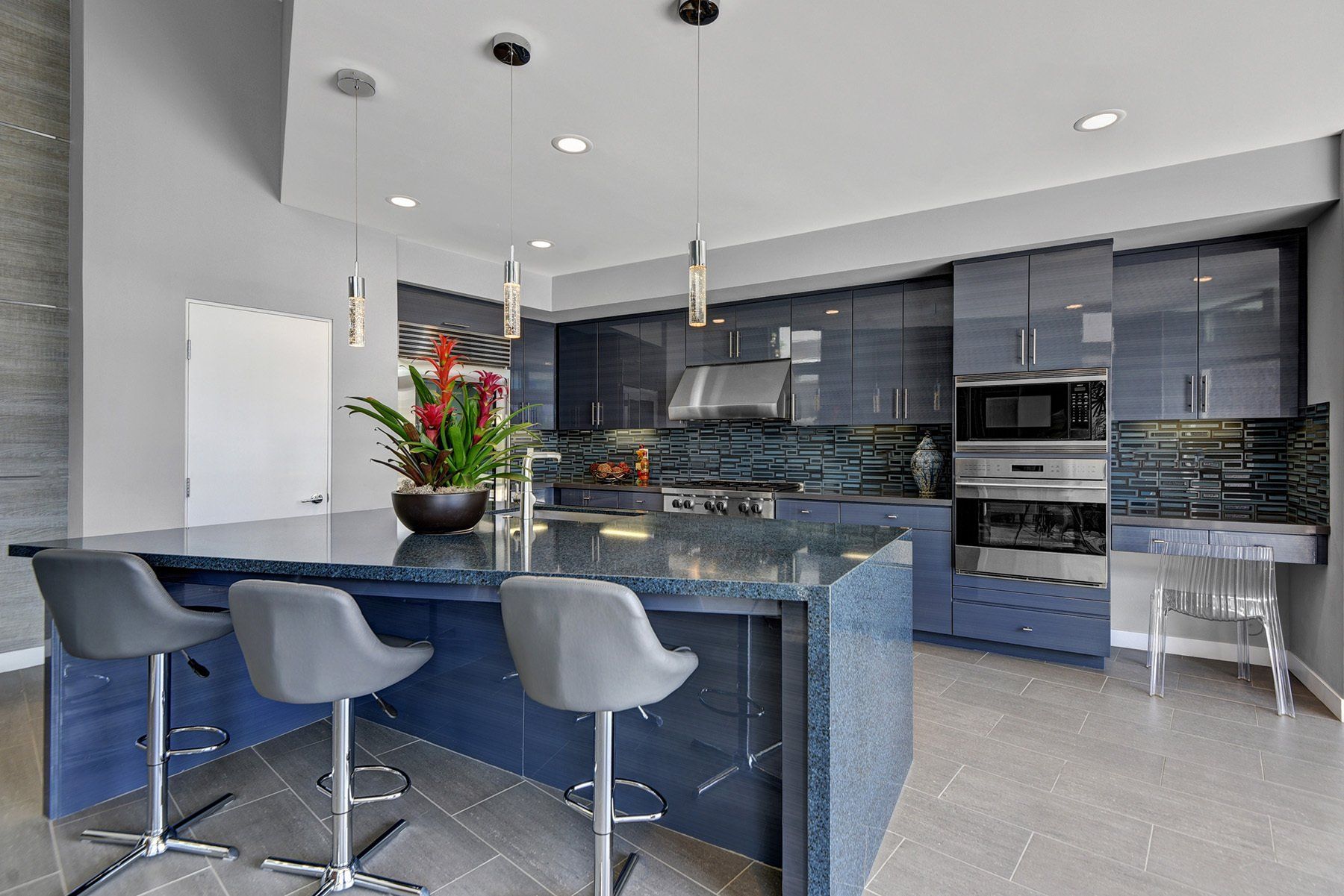 A kitchen with a large island and stools