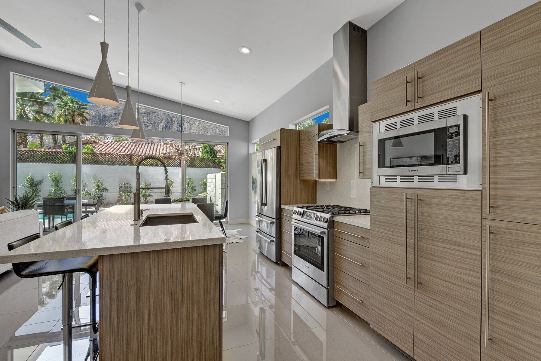A kitchen with stainless steel appliances and wooden cabinets.