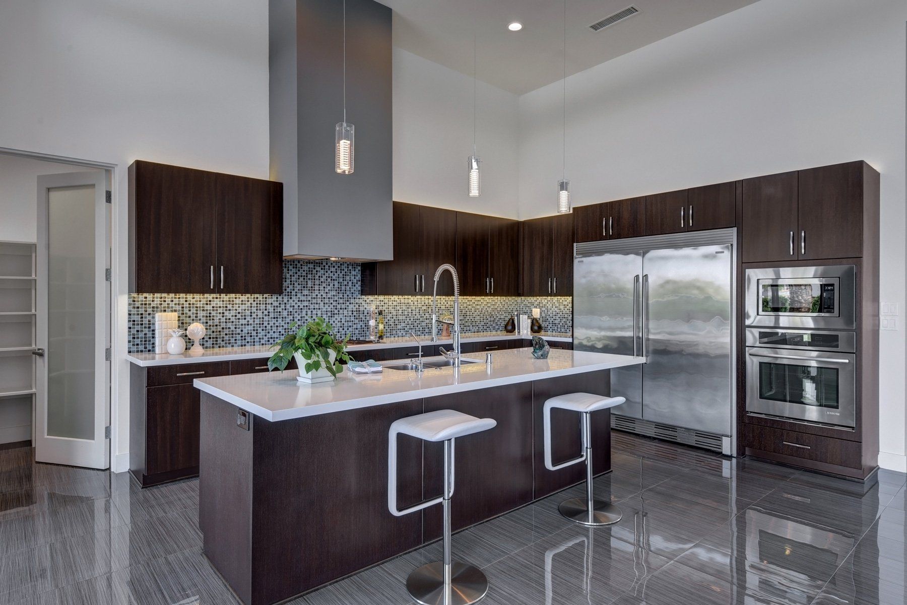 A kitchen with stainless steel appliances and a large island