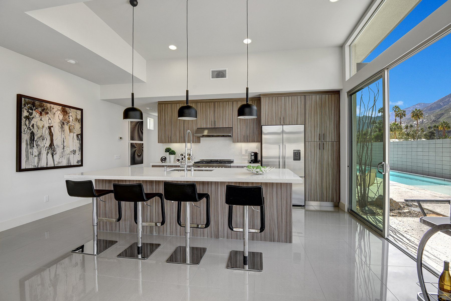 A modern kitchen with a large island and stools