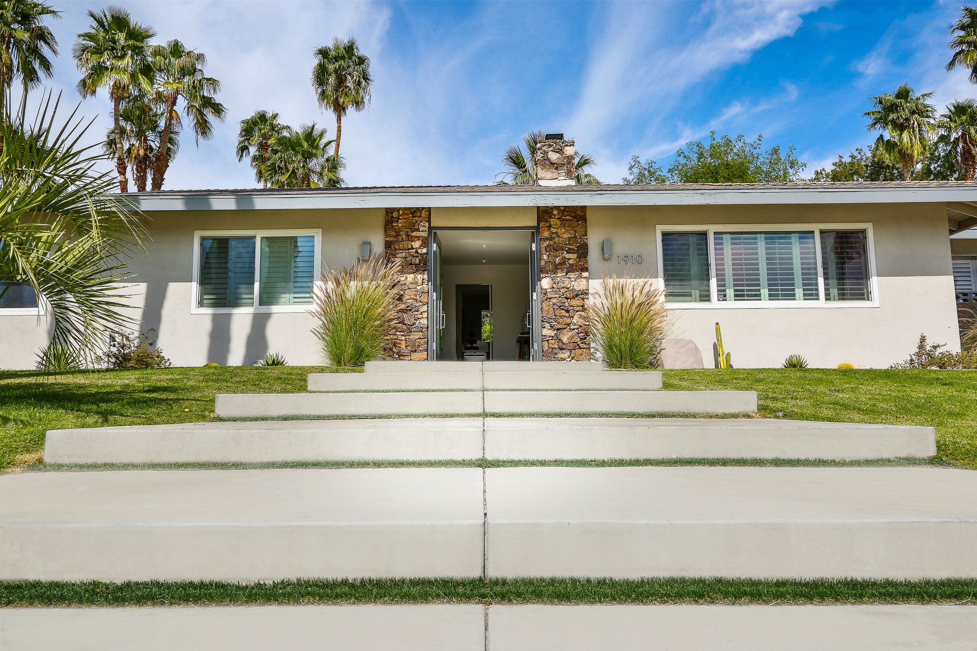The front of a house with concrete steps leading up to it