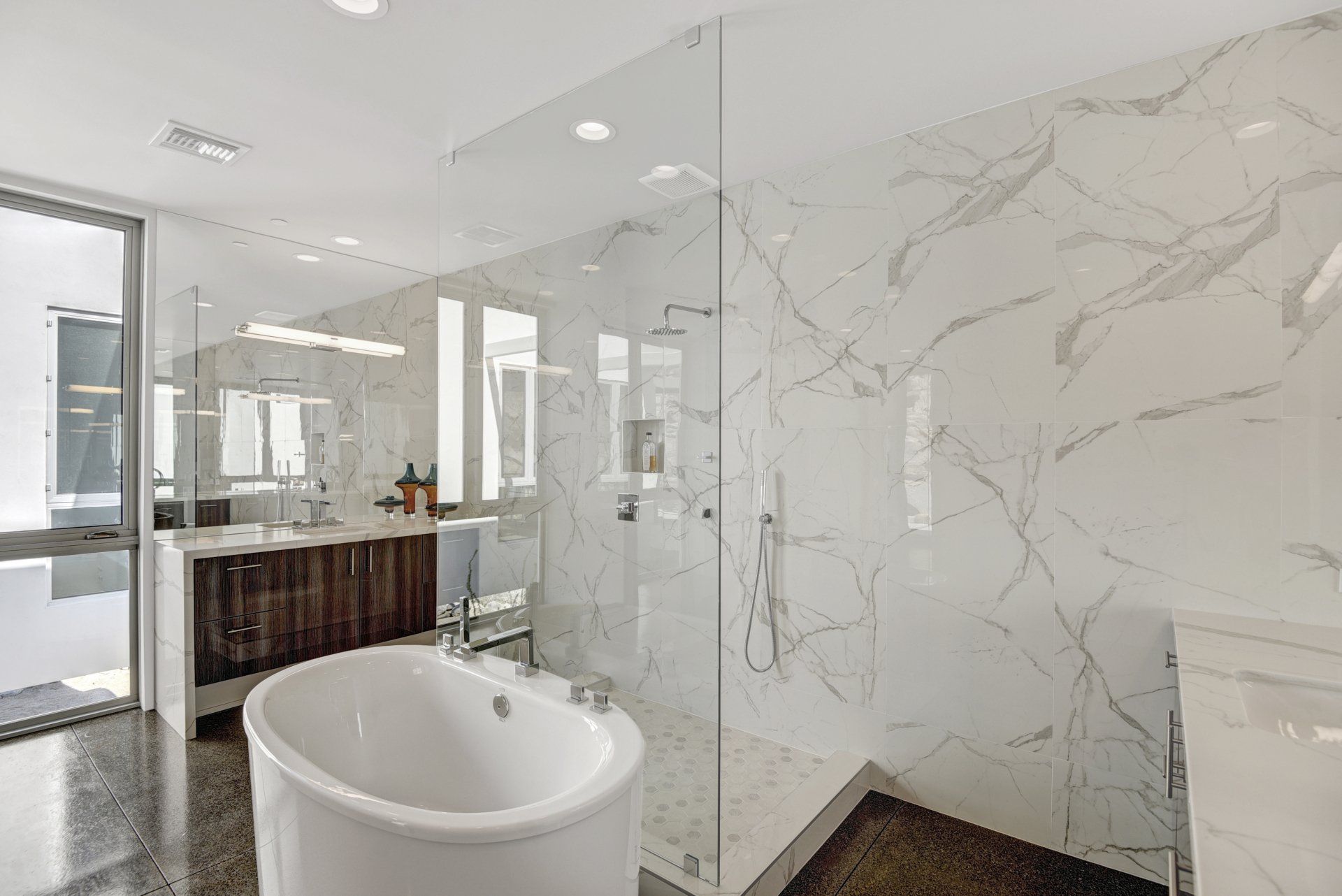 A bathroom with a bathtub and a walk in shower.