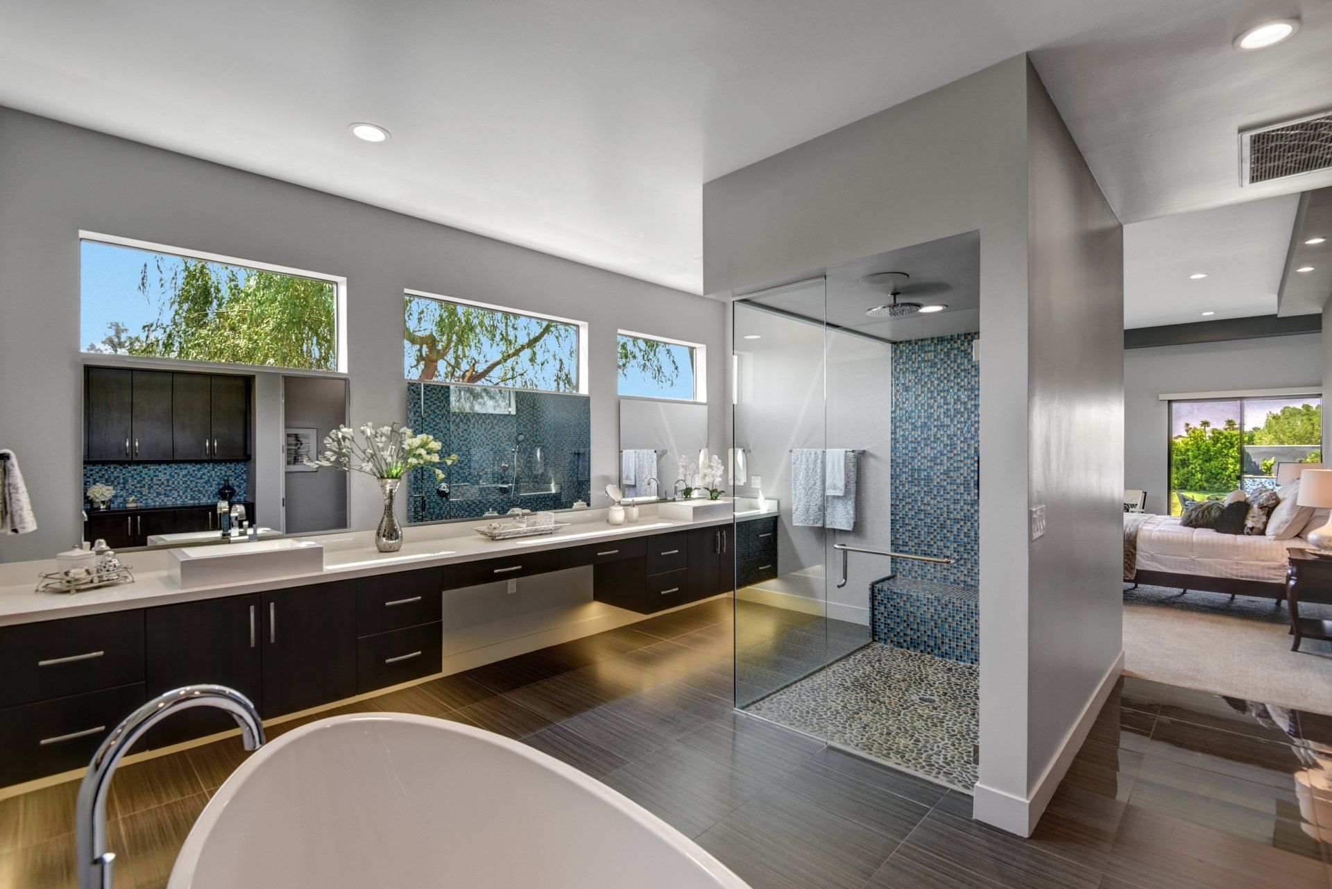 A bathroom with a bathtub , sinks , and a walk in shower.