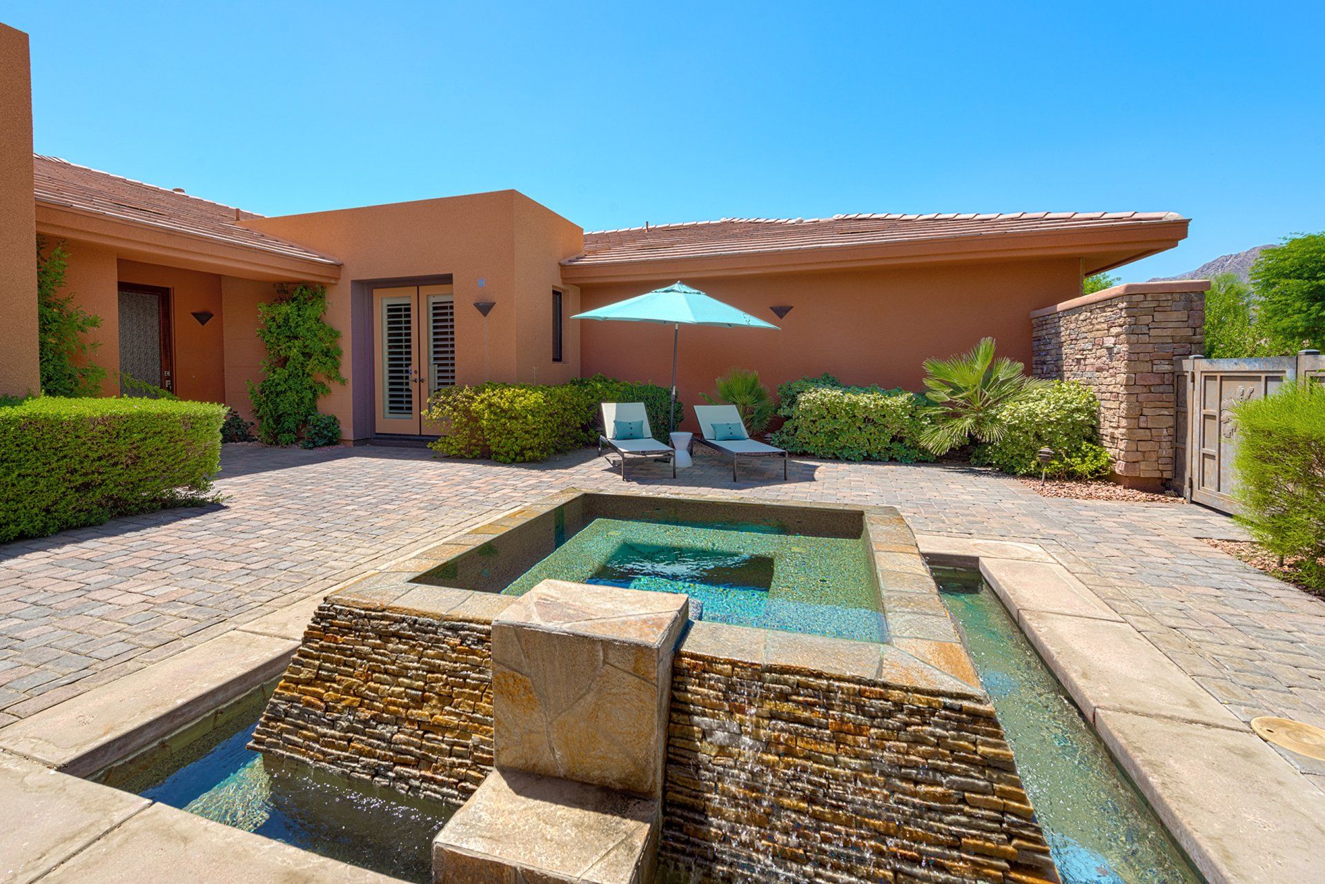 A large house with a swimming pool in front of it