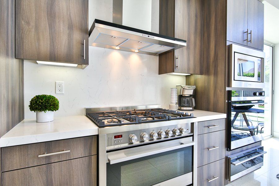 A kitchen with stainless steel appliances and wooden cabinets.