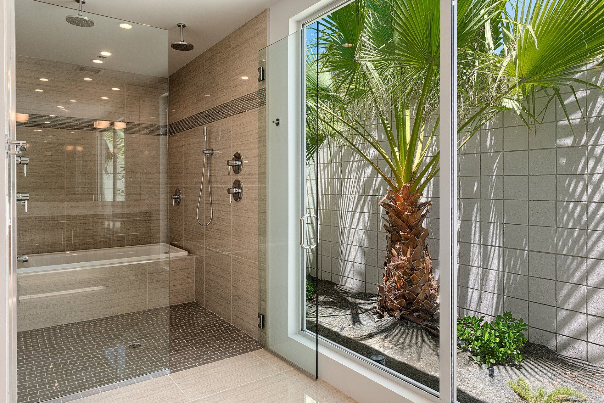 A bathroom with a walk in shower and a bathtub.