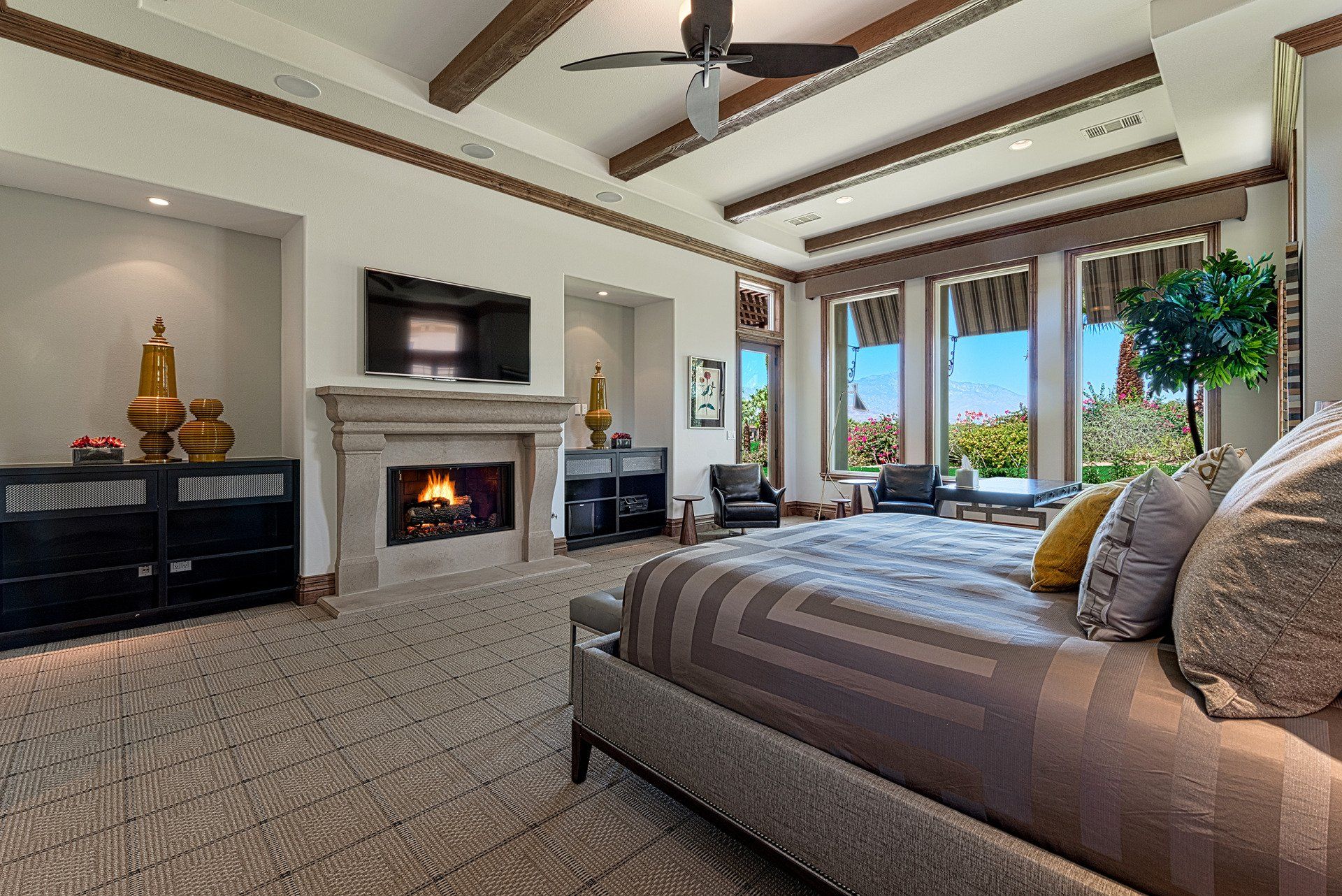 There is a fireplace in the middle of the bedroom.