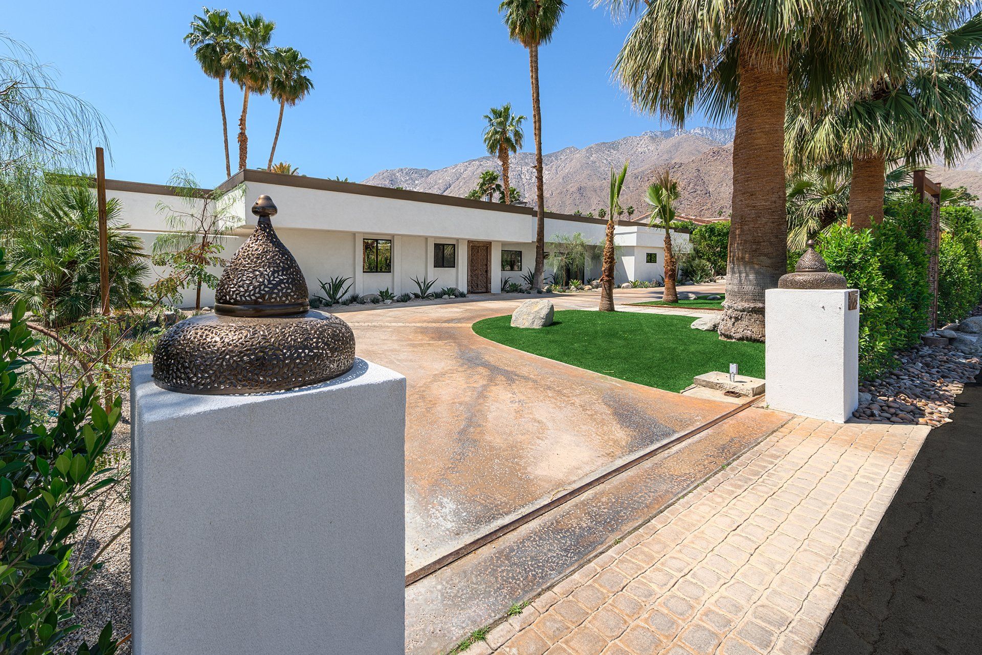 A large white house with palm trees in front of it