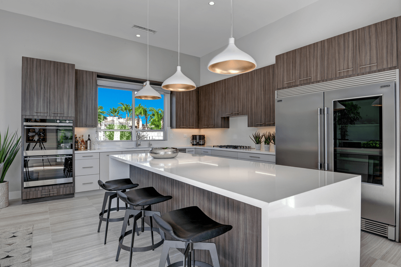 A kitchen with stainless steel appliances and a large island.