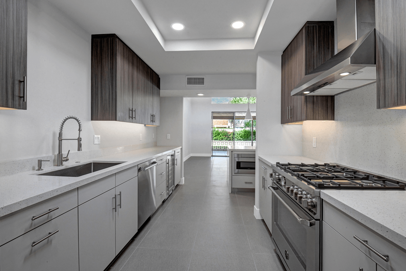 A kitchen with a stove , sink , and dishwasher.