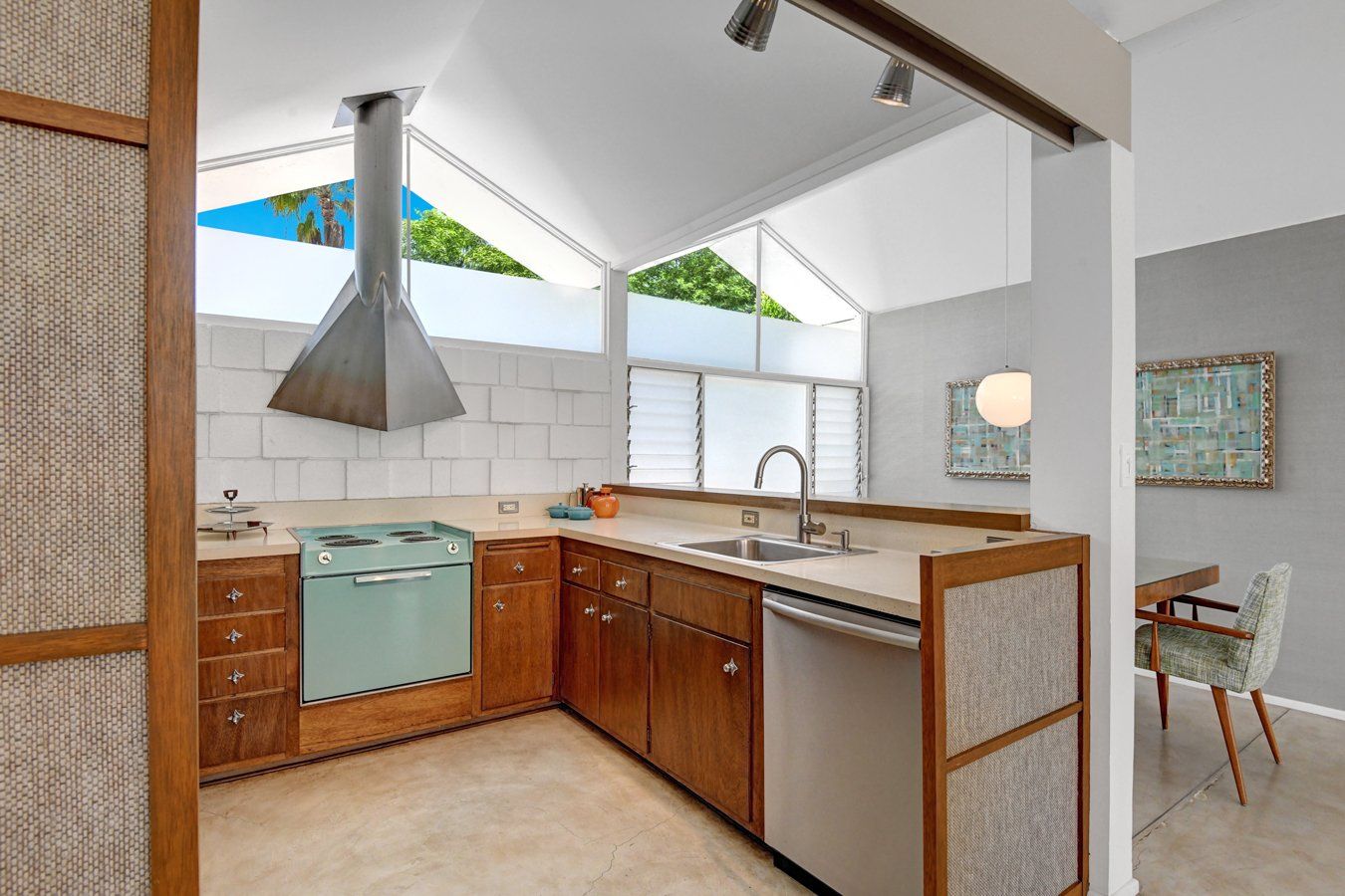 A kitchen with stainless steel appliances and wooden cabinets