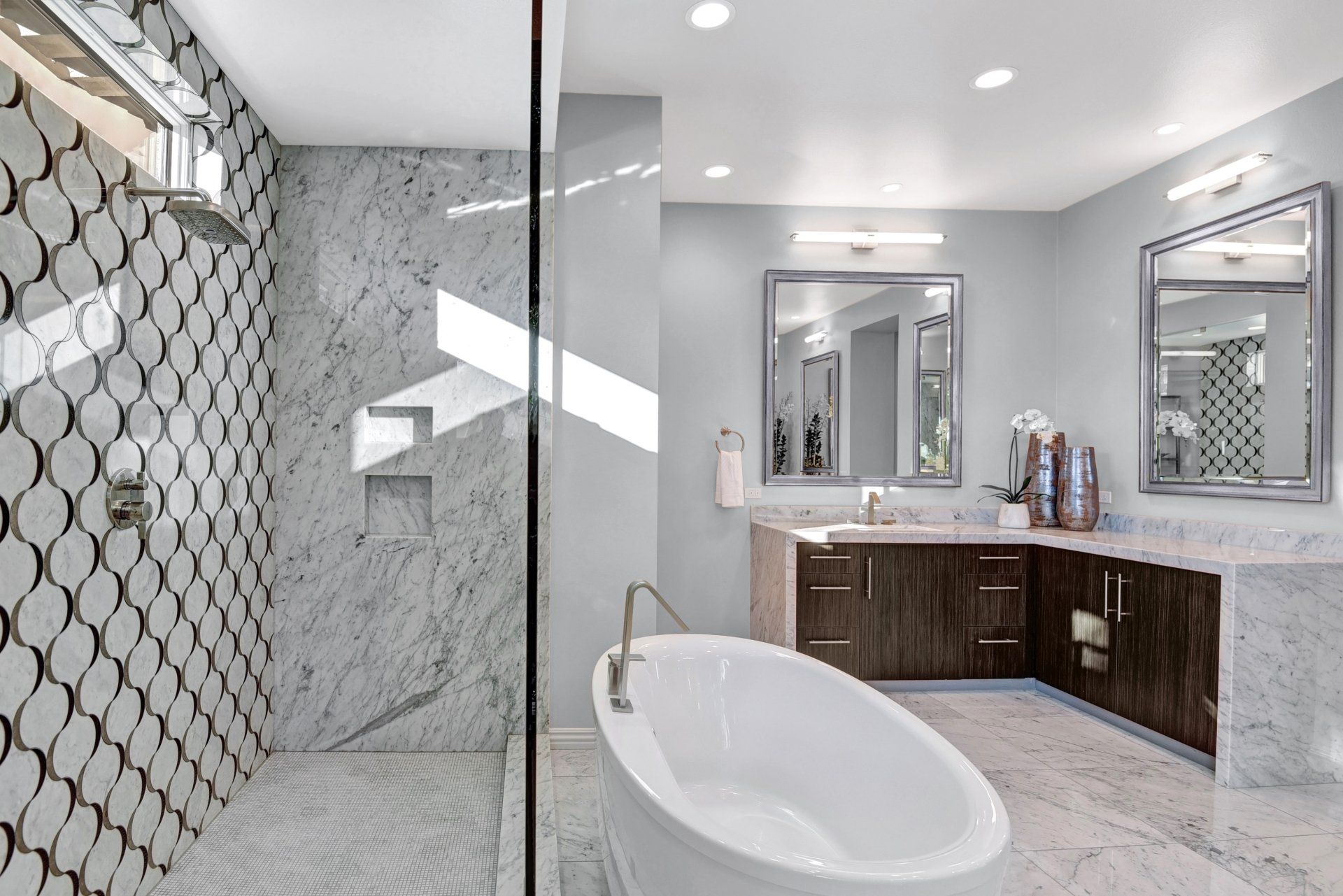 A bathroom with a bathtub and a walk in shower.