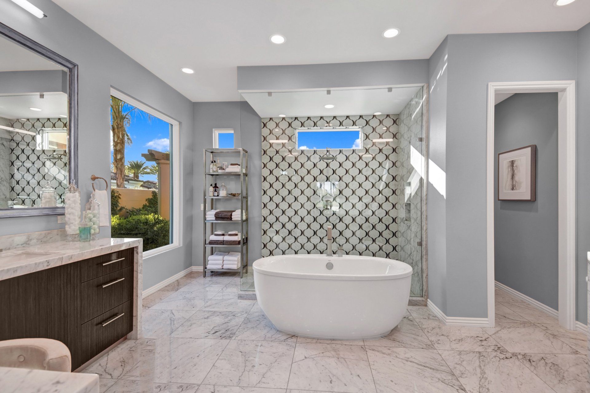 A bathroom with a tub , sink , mirror and shower.