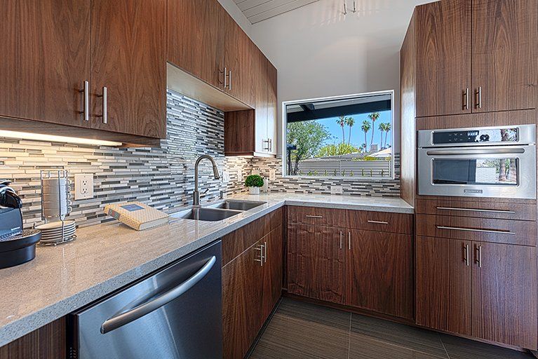 A kitchen with stainless steel appliances and wooden cabinets.