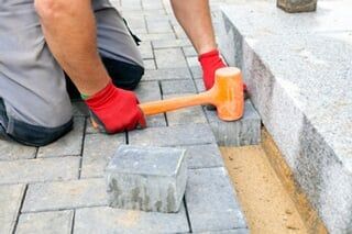 Landscaping Supplies — Worker Installing Pavement Rock in Philadelphia, PA Landscaping Supplies — Worker Installing Pavement Rock in Philadelphia, PA