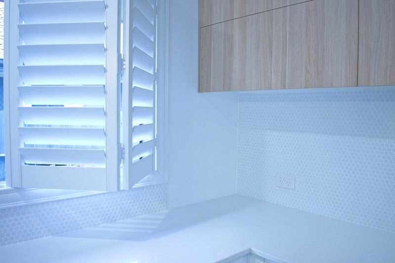 White Shutters on Kitchen — Denham Springs, LA — Blinds By Tones & Textures White Shutters on Kitchen — Denham Springs, LA — Blinds By Tones & Textures