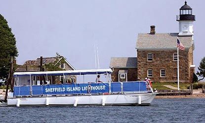 A boat that says sheffield island lighthouse on it