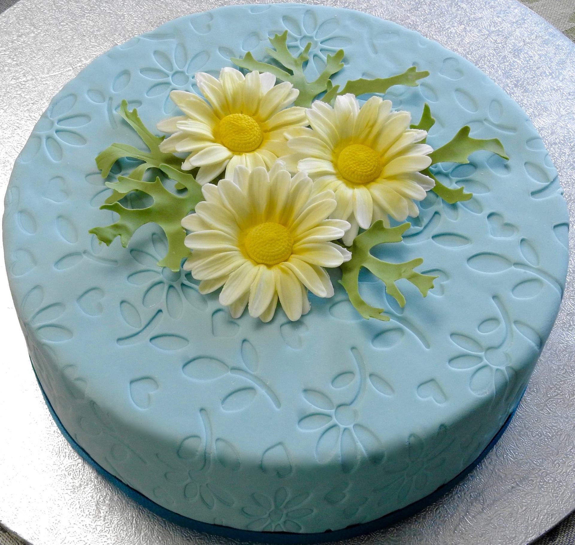 Ladies birthday cake embossed soft blue fondant and white sugar daisies
