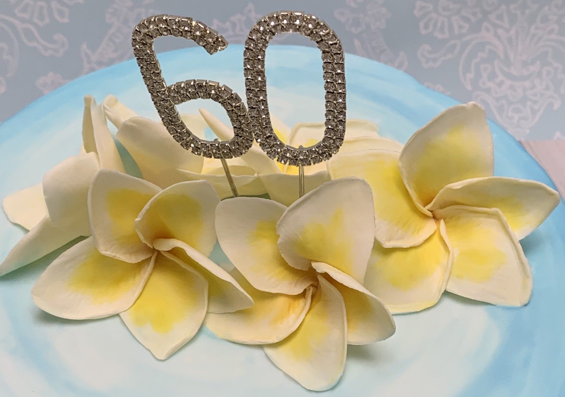 Close up of handmade sugar frangipani flowers and diamante 60