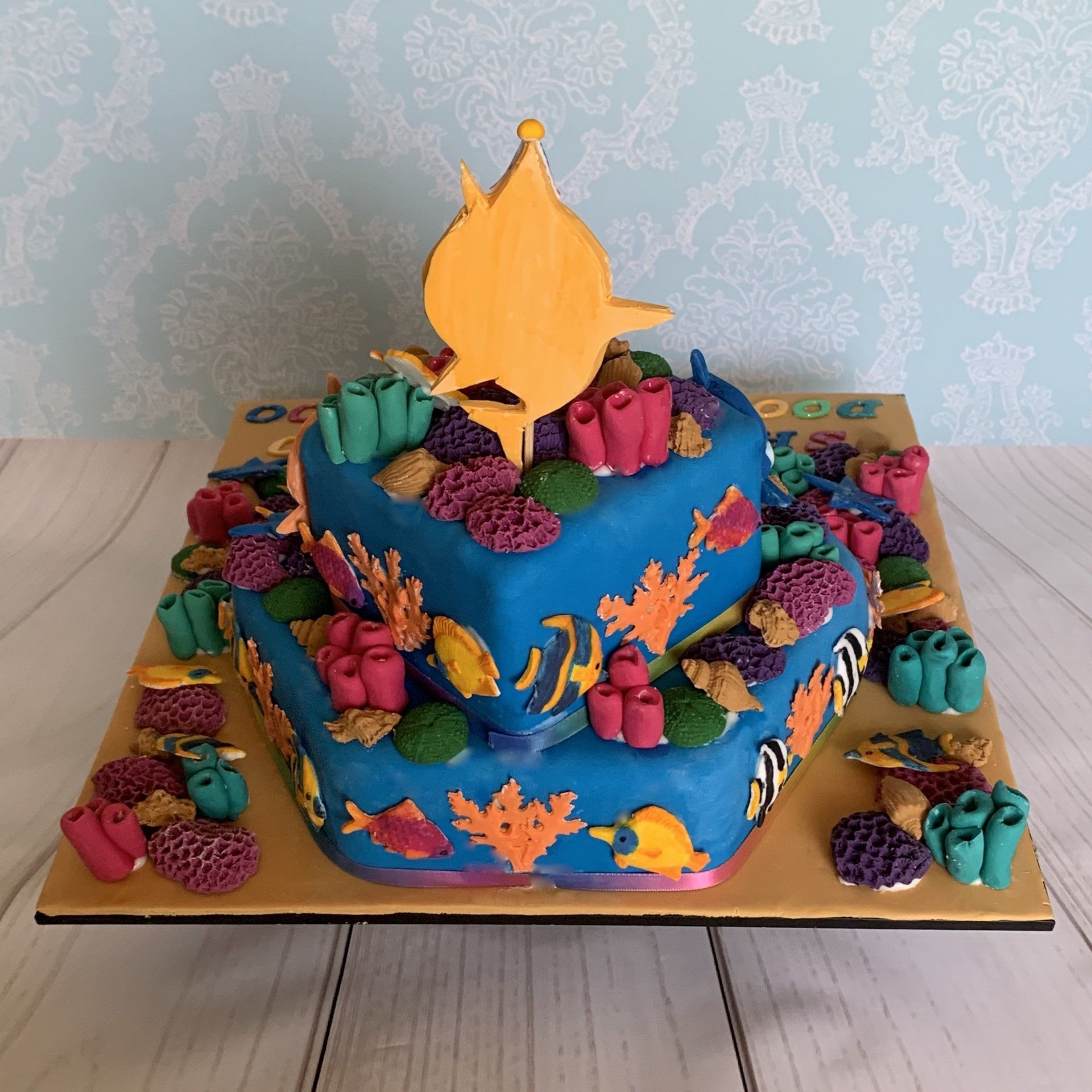 1st birthday cake. Famous hand cut fondant shark charchaters, lots of fondant coral, shells, fish and fondant sentiments. Back view